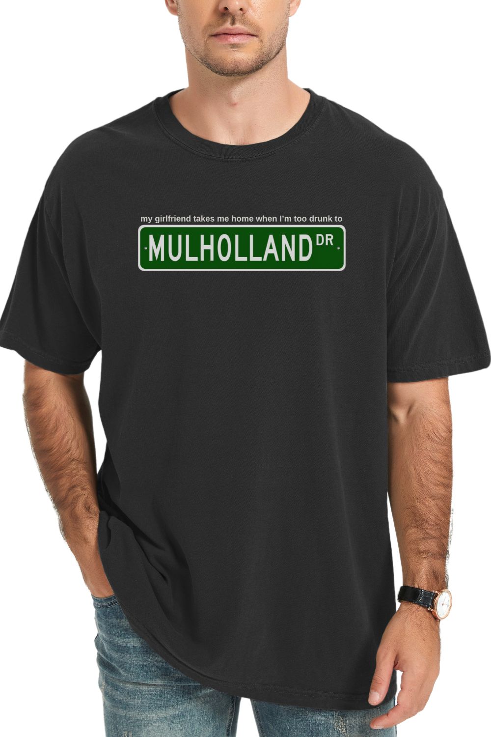 black t-shirt with Mulholland Drive street sign design on a white background, with blink 182 lyrics my girlfriend takes me home when I'm too drunk to drive, worn by a person