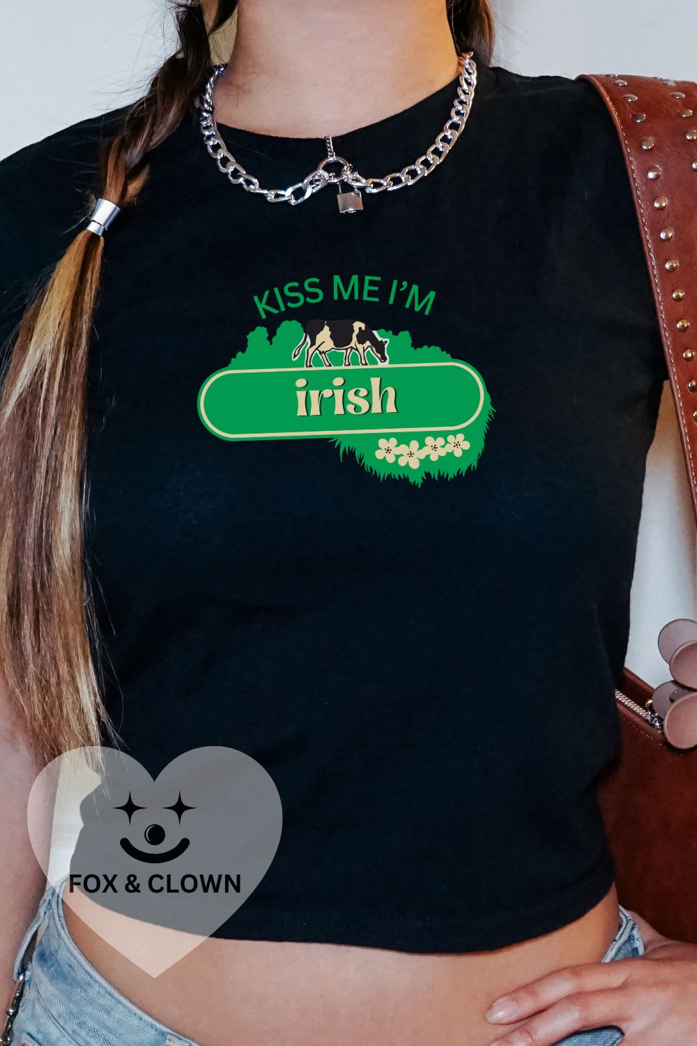 woman wearing 90s fit baby tee that says "kiss me I'm Irish" in the kerrygold butter logo