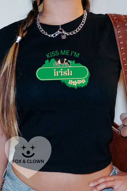 woman wearing 90s fit baby tee that says "kiss me I'm Irish" in the kerrygold butter logo