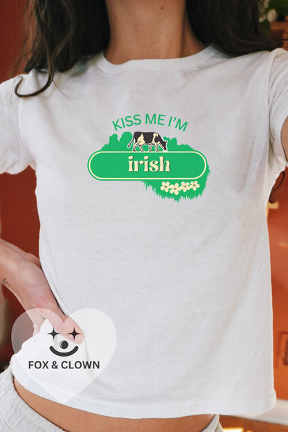 woman wearing 90s fit baby tee that says "kiss me I'm Irish" in the kerrygold butter logo