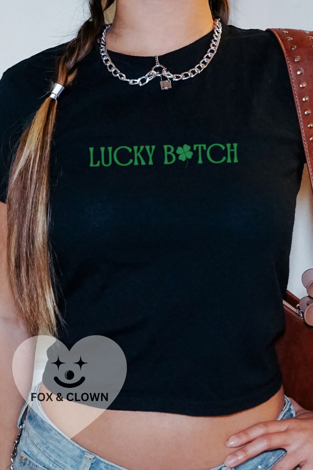 black st pattys day baby tee that says lukcy b*tch with a shamrock for the "I" in green