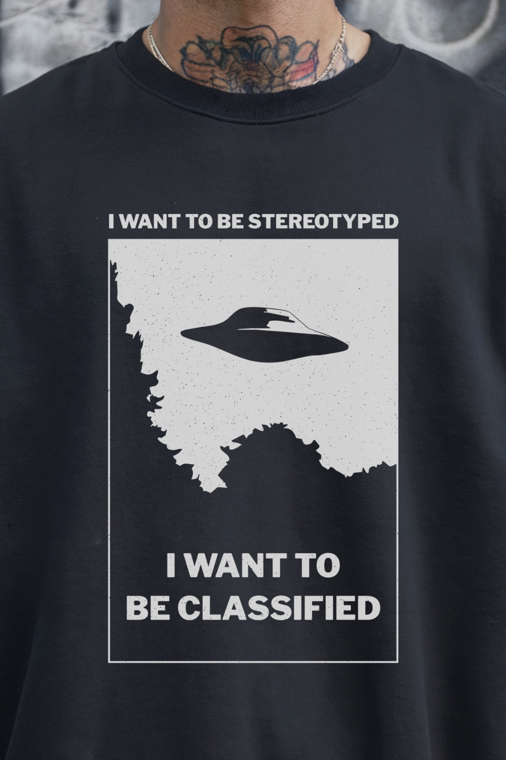 Black sweatshirt with a graphic design featuring a UFO and text on a gray background.