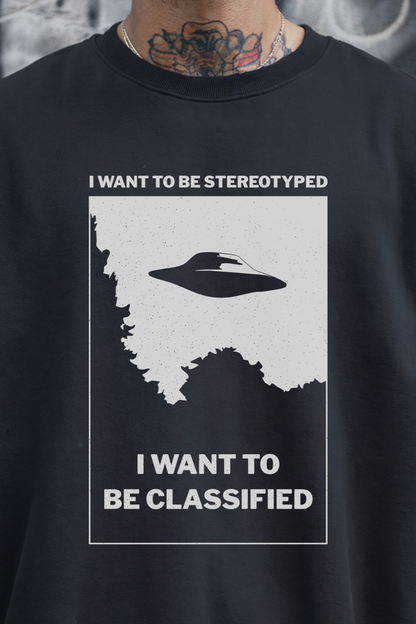 Black sweatshirt with a graphic design featuring a UFO and text on a gray background.